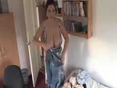 With her boobs out, my large-breasted wifey is making bed.